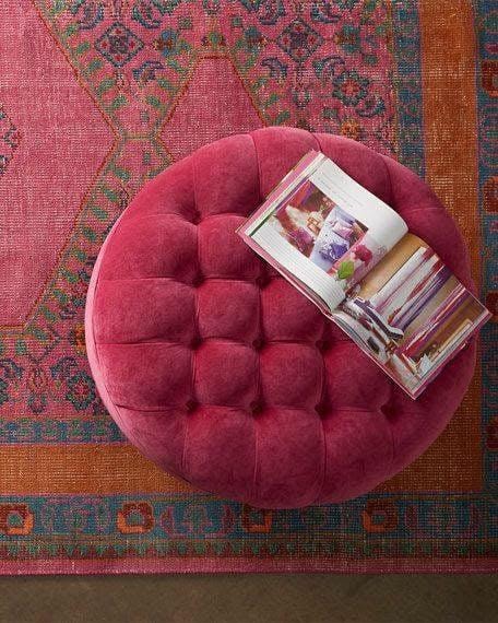 A cozy reading scene — book on a pink velvet ottoman